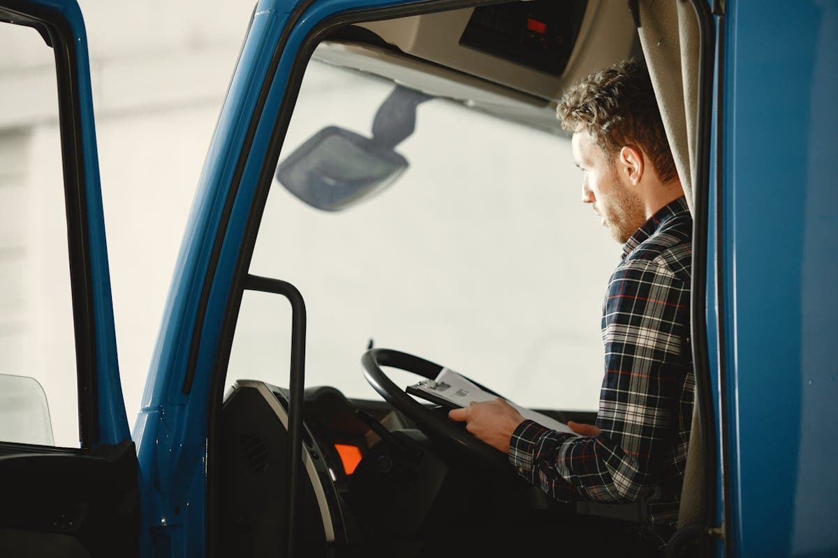 Professional truck driver reviewing documents in cab