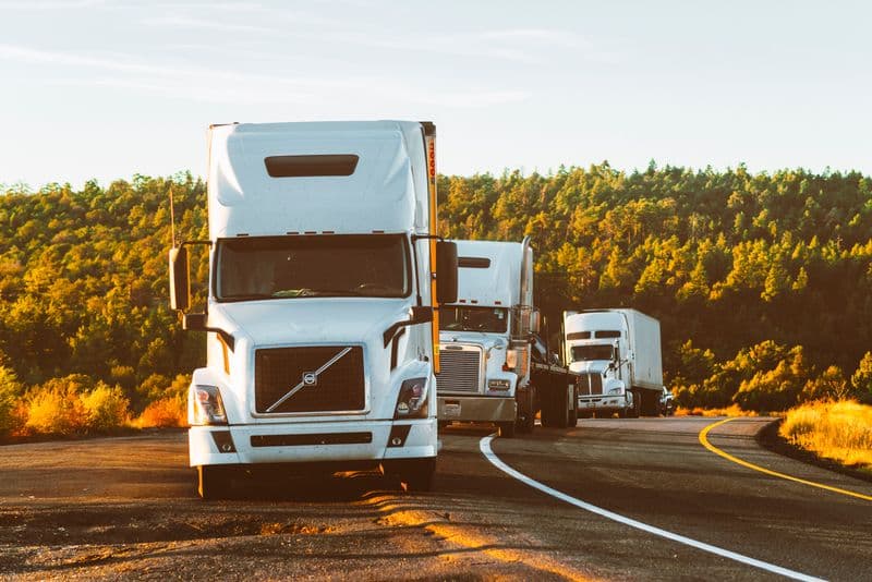 Fleet of Volvo HGV articulated lorries on an open road